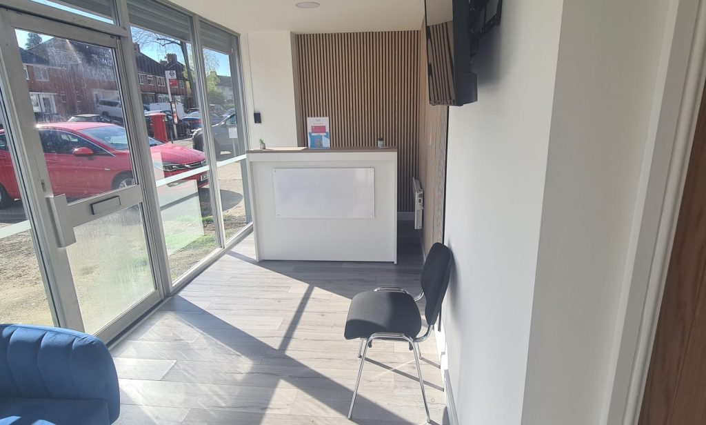 Inside view of a Birmingham clinic featuring a patient waiting area and reception area.