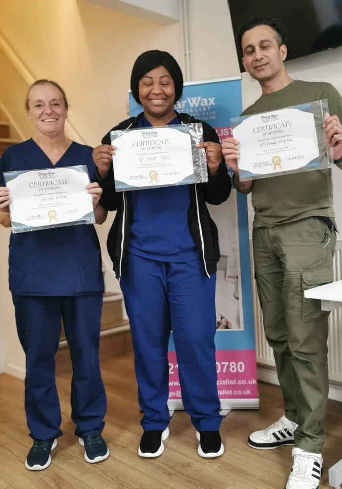 Professionals showing earwax removal training certificate