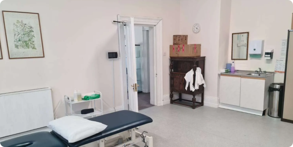 Audiologist performing professional ear wax removal procedure at Wolverhampton clinic.