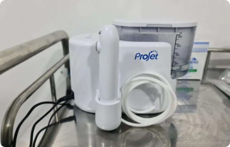 Close-up of ear wax removal procedure using microsuction equipment.